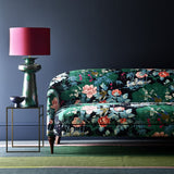 Sofa upholstered in an aqua coloured velvet upholstery fabric with a floral and bird design with a stain resistant finish.